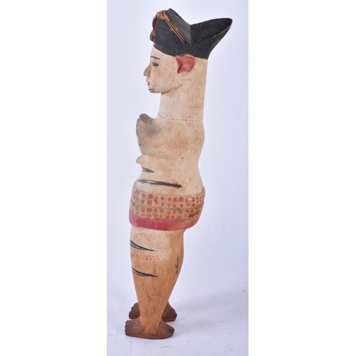 428 - AN UNUSUAL AFRICAN TRIBAL PAINTED WOOD FIGURE modelled with hands covering her breasts. 30cm high.