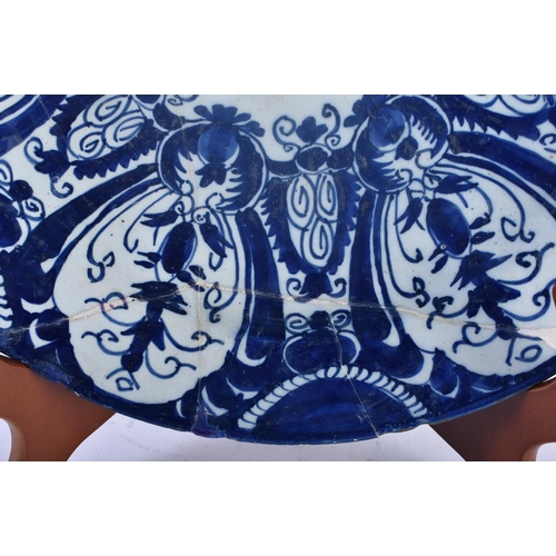 430 - A LARGE 18TH CENTURY DUTCH DELFT BLUE AND WHITE POTTERY DISH painted with flowers and motifs. 34 cm ... 