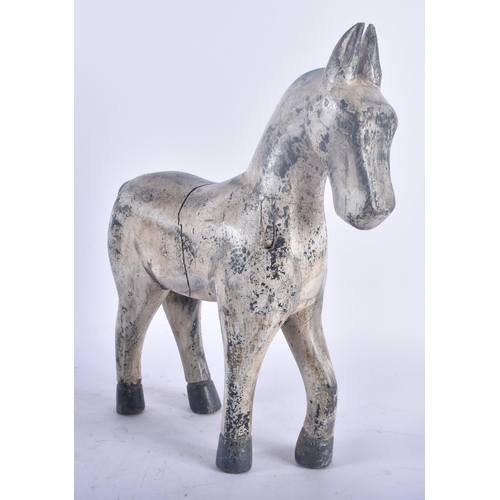 434 - A LARGE EARLY 20TH CENTURY CARVED FOLK ART PAINTED WOOD HORSE modelled standing. 36 cm x 22 cm.