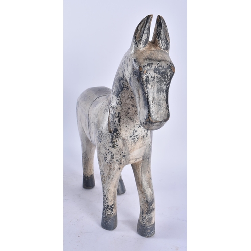 434 - A LARGE EARLY 20TH CENTURY CARVED FOLK ART PAINTED WOOD HORSE modelled standing. 36 cm x 22 cm.