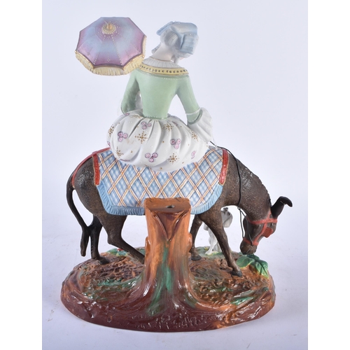 435 - A RARE 19TH CENTURY FRENCH BISQUE PORCELAIN FIGURE OF A FEMALE modelled riding upon a donkey with be... 