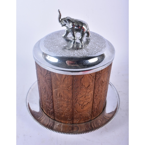 442 - AN ANGLO INDIAN SILVER PLATED CARVED WOOD ELEPHANT BISCUIT BARREL AND COVER together with a bronze e... 