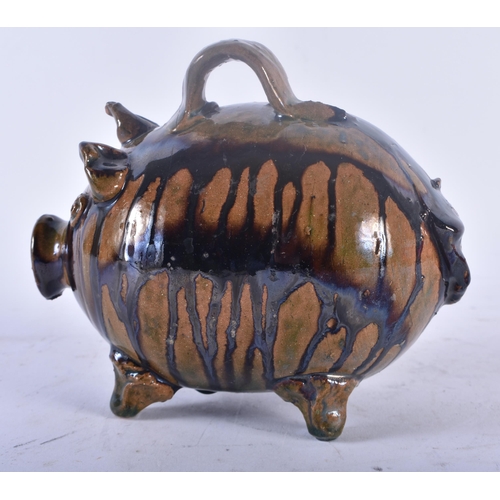 449 - A CHARMING ANTIQUE FOLK ART TREACLE GLAZED POTTERY PIG MONEY BOX. 15 cm x 12 cm.