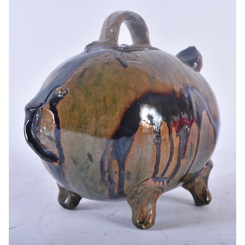 449 - A CHARMING ANTIQUE FOLK ART TREACLE GLAZED POTTERY PIG MONEY BOX. 15 cm x 12 cm.