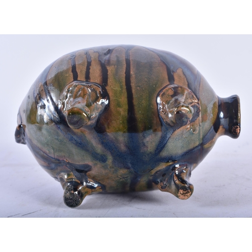 449 - A CHARMING ANTIQUE FOLK ART TREACLE GLAZED POTTERY PIG MONEY BOX. 15 cm x 12 cm.