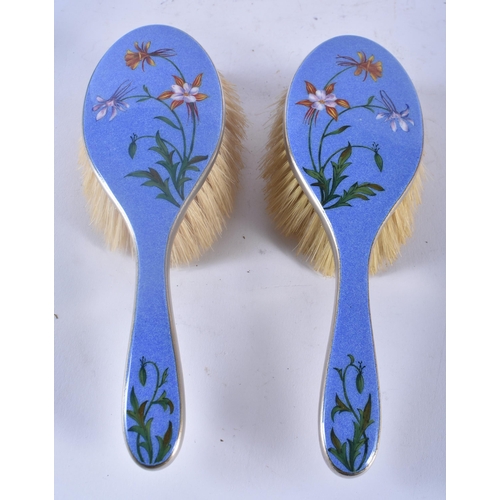 452 - AN ART DECO ENAMELLED DRESSING TABLE SET decorated with flowers. Largest 27cm x 12cm. (4)