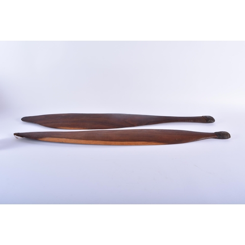 466 - TWO ABORIGINAL TRIBAL CARVED WOOD SHORT PADDLES engraved with motifs. 70 cm long. (2)