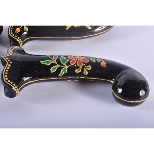 474 - A SET OF FIVE MIDDLE EASTERN QAJAR LACQUER HARDSTONE DAGGER HANDLES overlaid with foliage and vines.... 