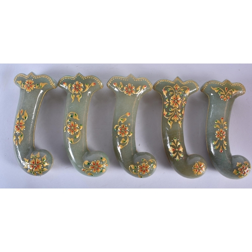 500 - A SET OF FIVE MIDDLE EASTERN QAJAR LACQUER HARDSTONE DAGGER HANDLES overlaid with foliage and vines.... 