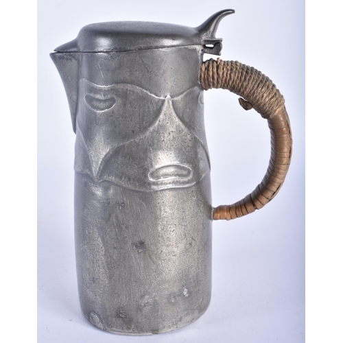 507 - AN ARCHIBALD KNOX TYPE LIBERTY STYLE PEWTER JUG. 15 cm high.