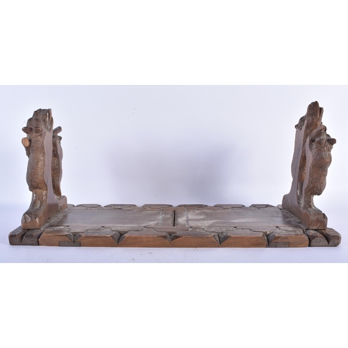 516 - A 19TH CENTURY BAVARIAN BLACK FOREST CARVED LINDEN WOOD EXTENDING BOOK RACK formed with two bears cl... 