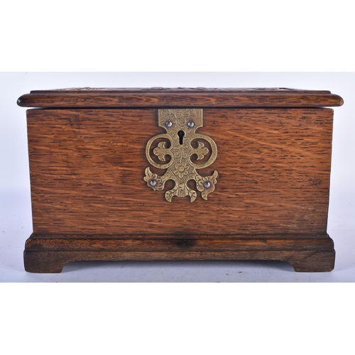 531 - AN ART NOUVEAU COPPER INSET OAK TEA CADDY decorated in relief with a scrolling plaque depicting foli... 