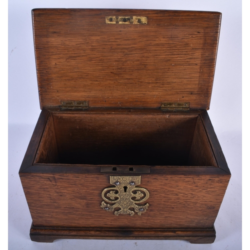 531 - AN ART NOUVEAU COPPER INSET OAK TEA CADDY decorated in relief with a scrolling plaque depicting foli... 