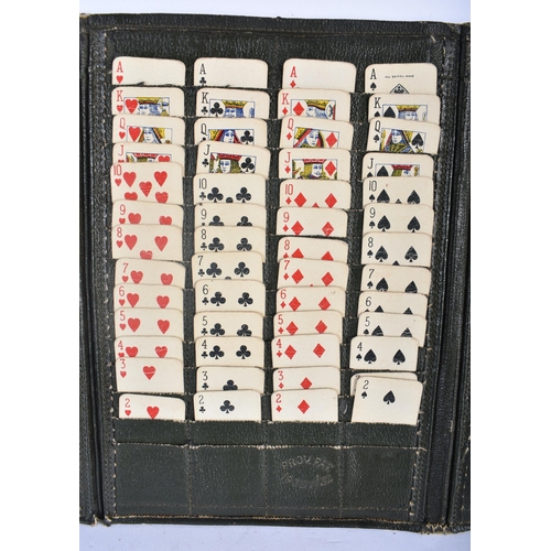 535 - A VINTAGE LEATHER CASED TRAVELLING SOLITAIRE CARD GAME. 24 cm x 15 cm.