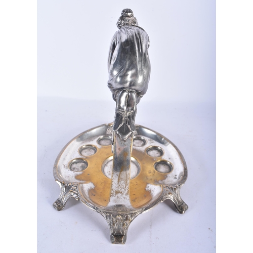 550 - AN UNUSUAL WMF SILVER PLATED DECANTER AND GLASS STAND formed with a leaning female. 24 cm x 18cm.