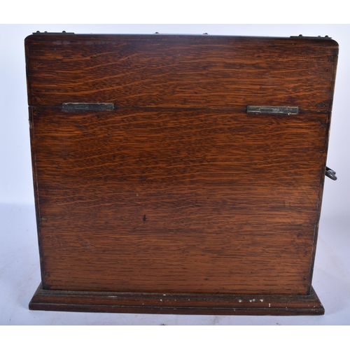 554 - A LARGE LATE VICTORIAN OAK CASED TANTALUS the top and front opening to reveal a fully fitted interio... 