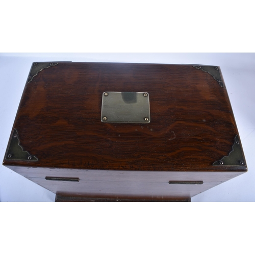 554 - A LARGE LATE VICTORIAN OAK CASED TANTALUS the top and front opening to reveal a fully fitted interio... 