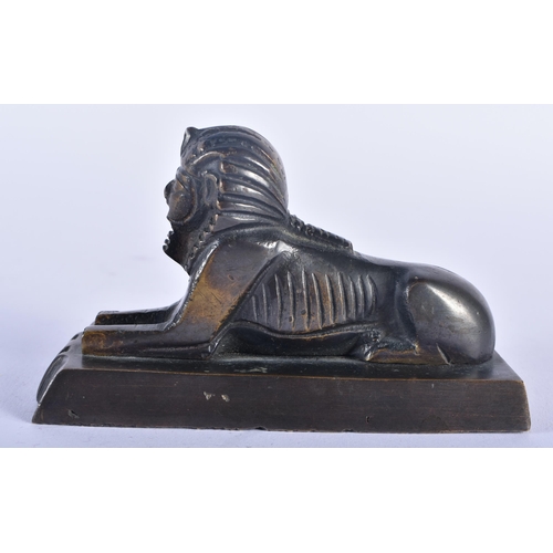 566 - AN ANTIQUE EGYPTIAN REVIVAL BRONZE SPHINX together with a pair of cats. Largest 16 cm high. (3)