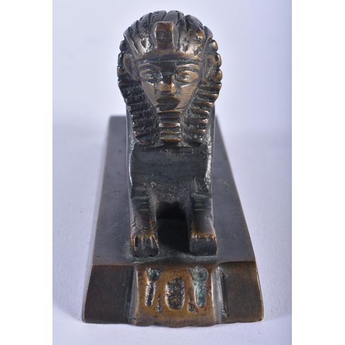 566 - AN ANTIQUE EGYPTIAN REVIVAL BRONZE SPHINX together with a pair of cats. Largest 16 cm high. (3)