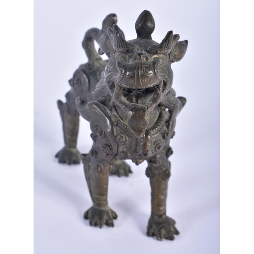 568 - AN 18TH CENTURY CAMBODIAN BRONZE FIGURE OF A ROAMING BEAST modelled scowling. 10 cm x 10 cm.