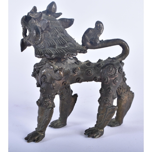 568 - AN 18TH CENTURY CAMBODIAN BRONZE FIGURE OF A ROAMING BEAST modelled scowling. 10 cm x 10 cm.