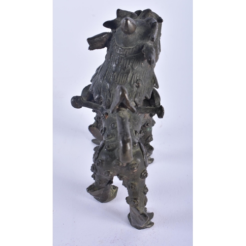 568 - AN 18TH CENTURY CAMBODIAN BRONZE FIGURE OF A ROAMING BEAST modelled scowling. 10 cm x 10 cm.