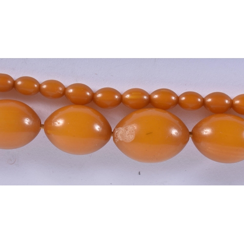 572 - FOUR VINTAGE AMBER TYPE NECKLACES. 183 grams. Largest 88 cm long. (4)