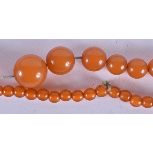 572 - FOUR VINTAGE AMBER TYPE NECKLACES. 183 grams. Largest 88 cm long. (4)