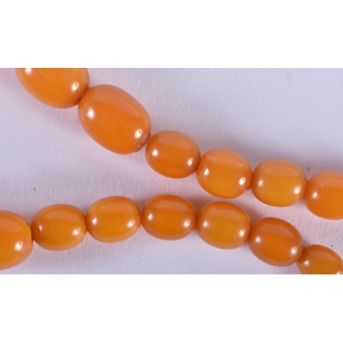 572 - FOUR VINTAGE AMBER TYPE NECKLACES. 183 grams. Largest 88 cm long. (4)