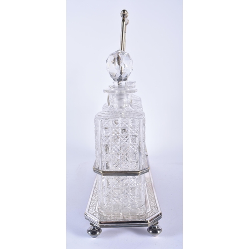 600 - AN ANTIQUE SILVER PLATED CUT GLASS TANTALUS. 38 cm x 32 cm.