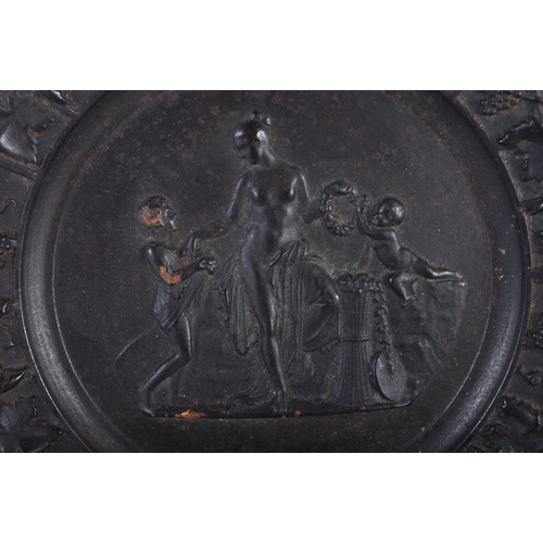 611 - A SET OF FOUR 19TH CENTURY GRAND TOUR CAST IRON CLASSICAL PLAQUES decorated with a border of grape v... 