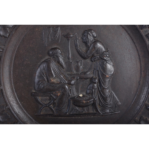 611 - A SET OF FOUR 19TH CENTURY GRAND TOUR CAST IRON CLASSICAL PLAQUES decorated with a border of grape v... 