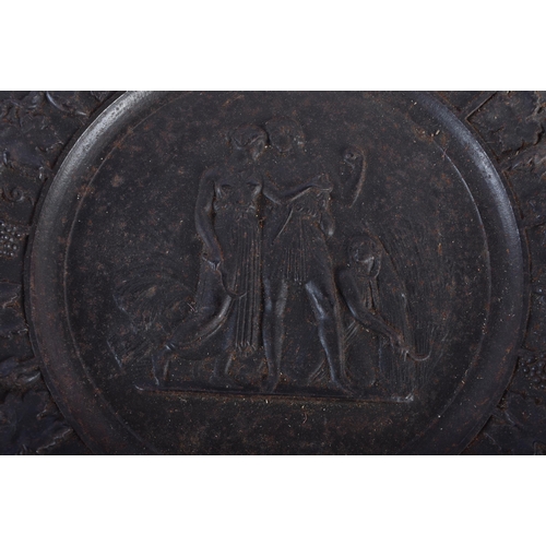 611 - A SET OF FOUR 19TH CENTURY GRAND TOUR CAST IRON CLASSICAL PLAQUES decorated with a border of grape v... 