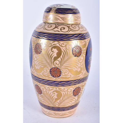 619 - A RARE CARLTON WARE VASE AND COVER painted with Islamic style motifs. 22 cm x 11cm.