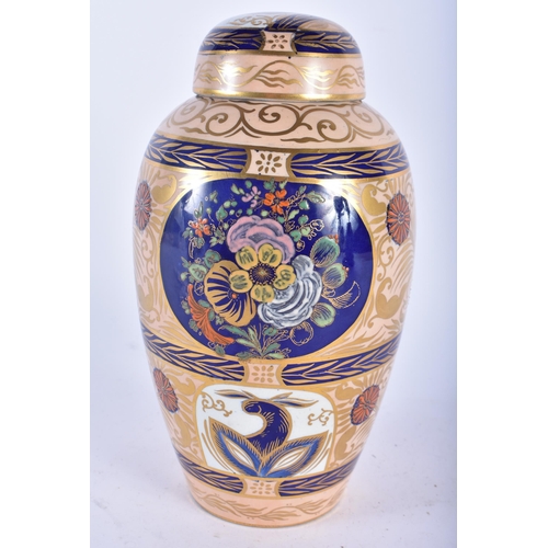 619 - A RARE CARLTON WARE VASE AND COVER painted with Islamic style motifs. 22 cm x 11cm.