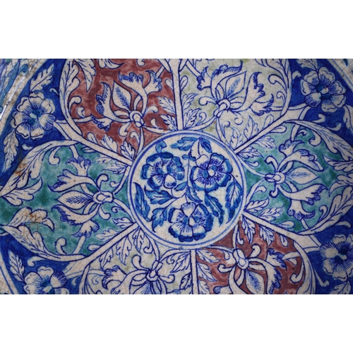 63 - A RARE LARGE 19TH CENTURY MIDDLE EASTERN ISLAMIC IZNIK TYPE POTTERY BASIN painted with panels of fol... 