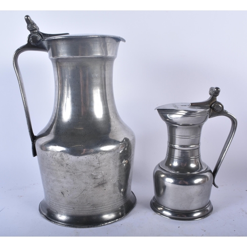 649 - TWO PEWTER FLAGONS together with a bronze desk stand. Largest 30cm x 22 cm. (3)