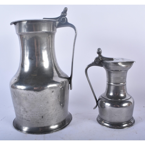 649 - TWO PEWTER FLAGONS together with a bronze desk stand. Largest 30cm x 22 cm. (3)