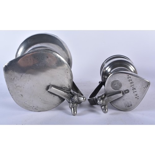 649 - TWO PEWTER FLAGONS together with a bronze desk stand. Largest 30cm x 22 cm. (3)