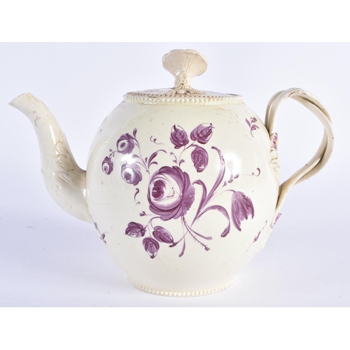 65 - AN 18TH CENTURY ENGLISH CREAMWARE TEAPOT AND COVER painted with flowers. 18cm wide.