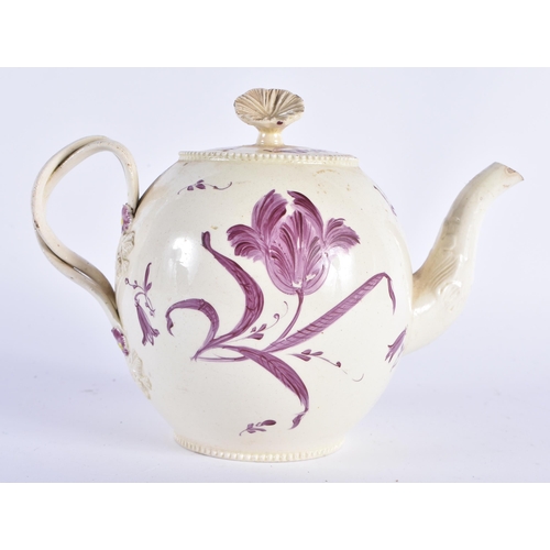 65 - AN 18TH CENTURY ENGLISH CREAMWARE TEAPOT AND COVER painted with flowers. 18cm wide.