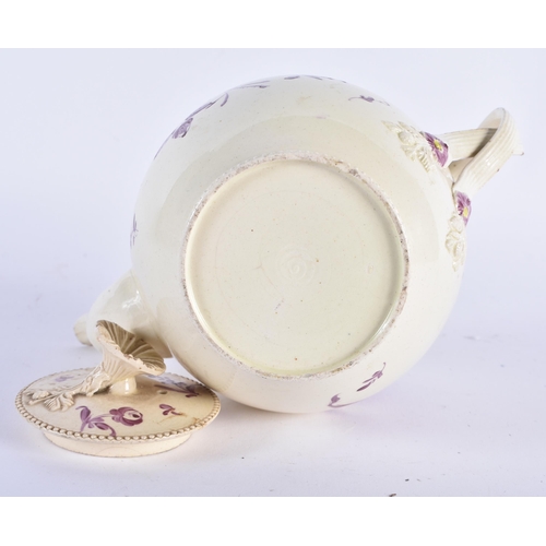 65 - AN 18TH CENTURY ENGLISH CREAMWARE TEAPOT AND COVER painted with flowers. 18cm wide.