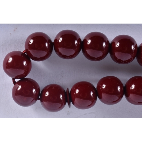 650 - A TURKISH CHERRY AMBER TYPE TESBIH NECKLACE. 93 grams. 94 cm long.