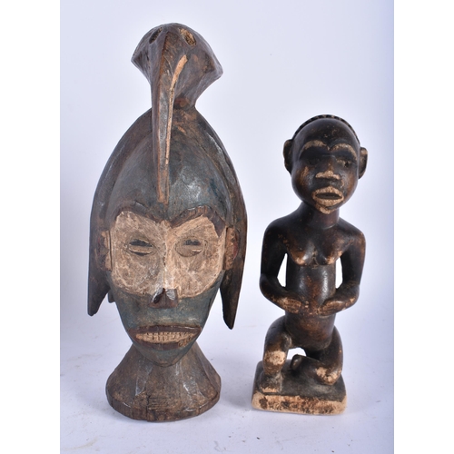 664 - A TRIBAL BIRD HEAD WOOD MASK together with another African figure. Largest 26cm high. (5)