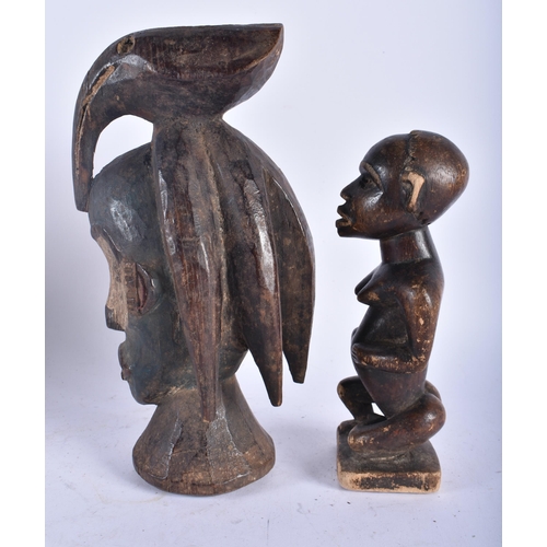 664 - A TRIBAL BIRD HEAD WOOD MASK together with another African figure. Largest 26cm high. (5)