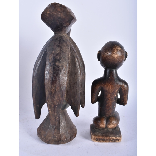 664 - A TRIBAL BIRD HEAD WOOD MASK together with another African figure. Largest 26cm high. (5)