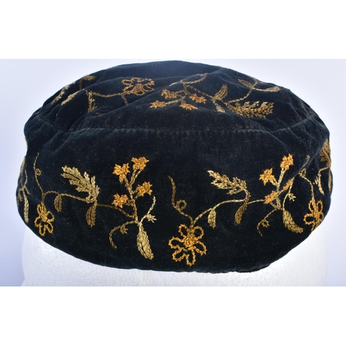 697 - AN ANTIQUE EMBROIDERED VELVET SMOKERS CAP. 18cm wide.