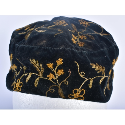 697 - AN ANTIQUE EMBROIDERED VELVET SMOKERS CAP. 18cm wide.