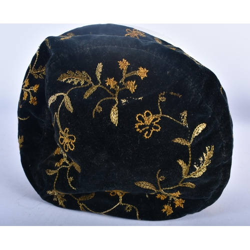 697 - AN ANTIQUE EMBROIDERED VELVET SMOKERS CAP. 18cm wide.