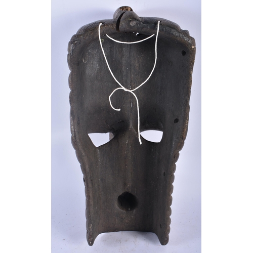 705 - A LARGE AFRICAN TRIBAL CARVED WOOD MASK. 45cm x 15 cm.